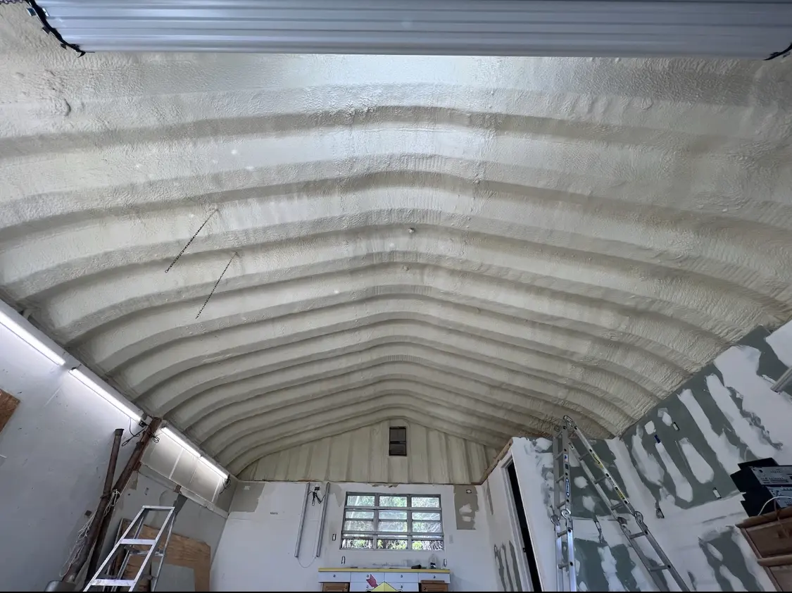 Spray polyurethane foam applied to the underside of a metal roof deck in Niles